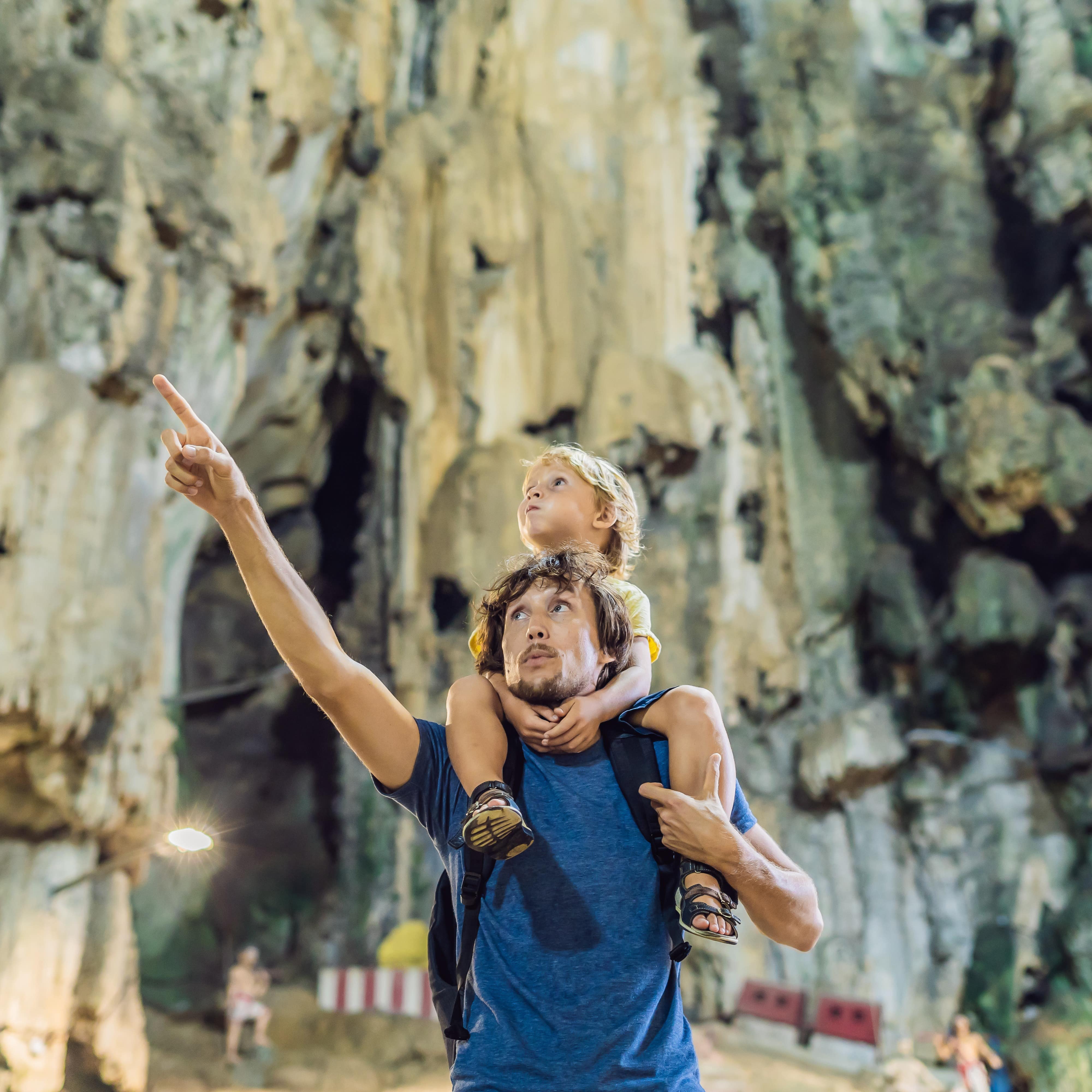 Father and son exploring cave