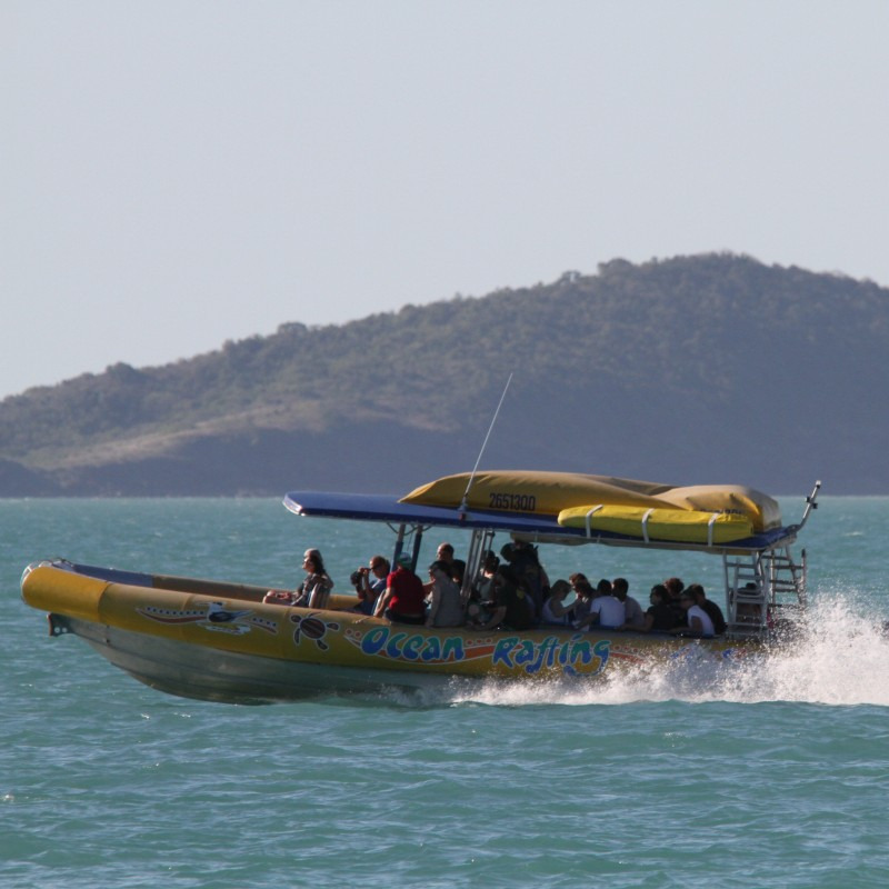 A rafting boat sails through the ocean near Sunshine Beach.