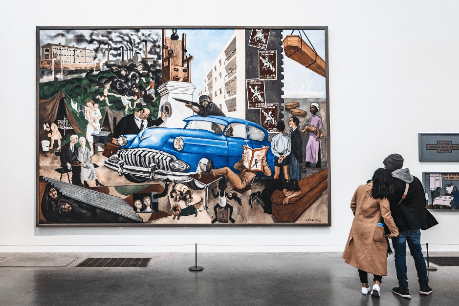 couple looking at a painting in a gallery