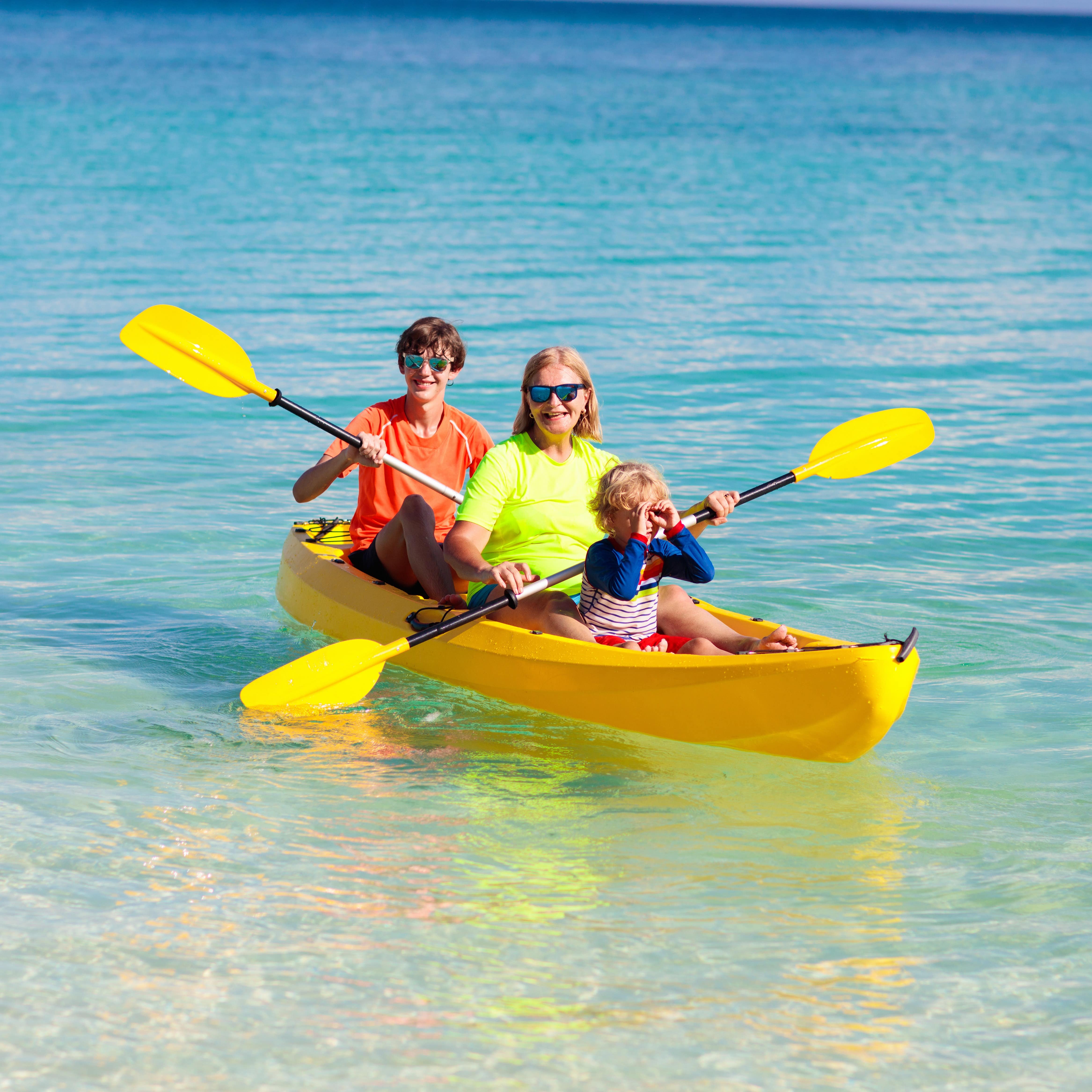 Family kayaking in ocean