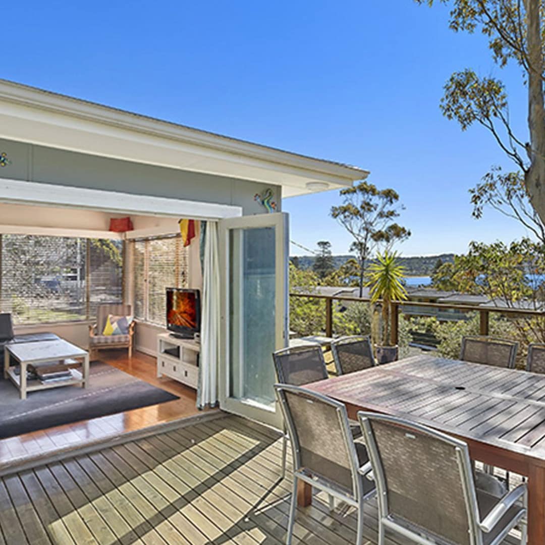 Porch of waterfront beach house looking out on shore