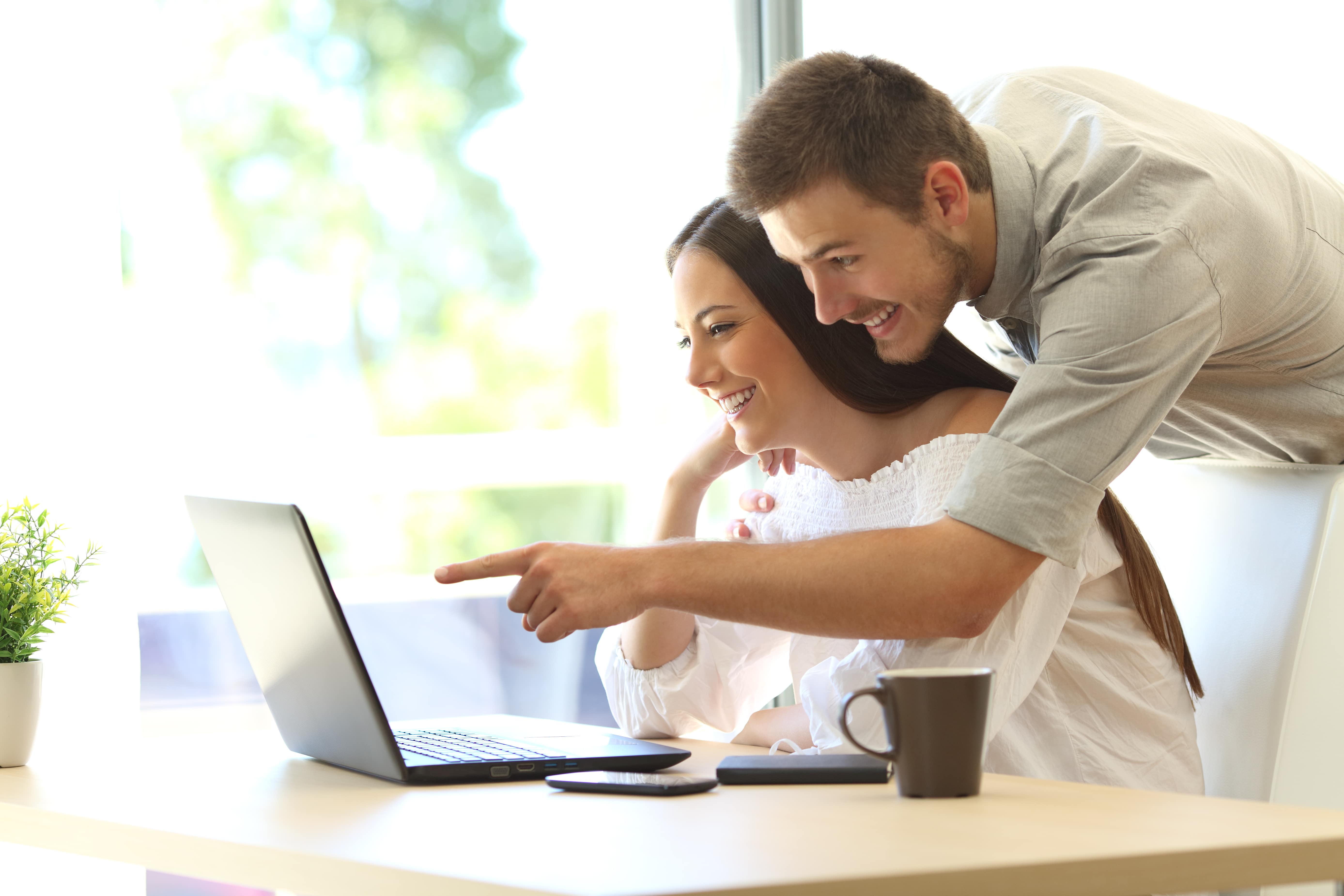 Couple planning holiday on computer