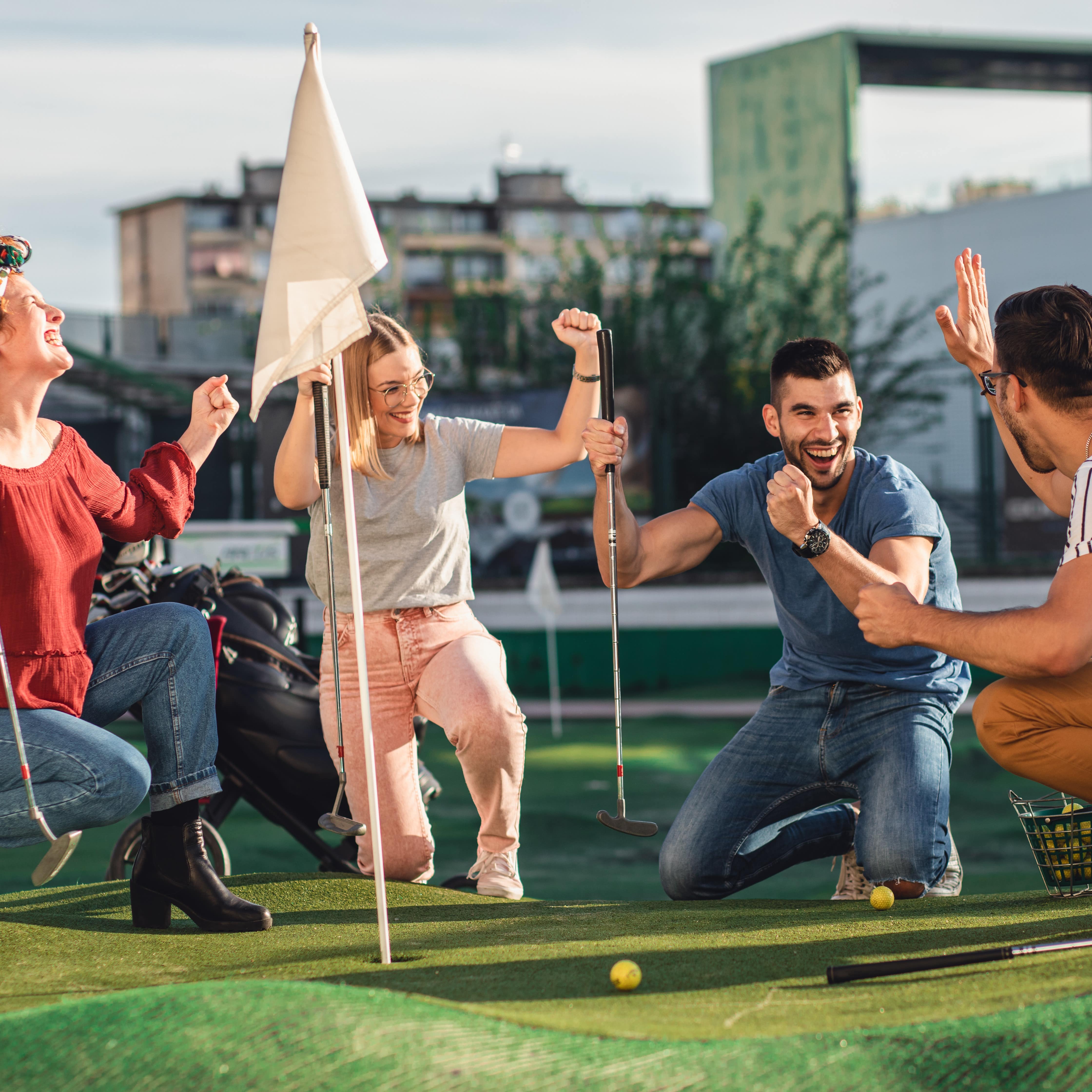 Group of friends playing mini golf