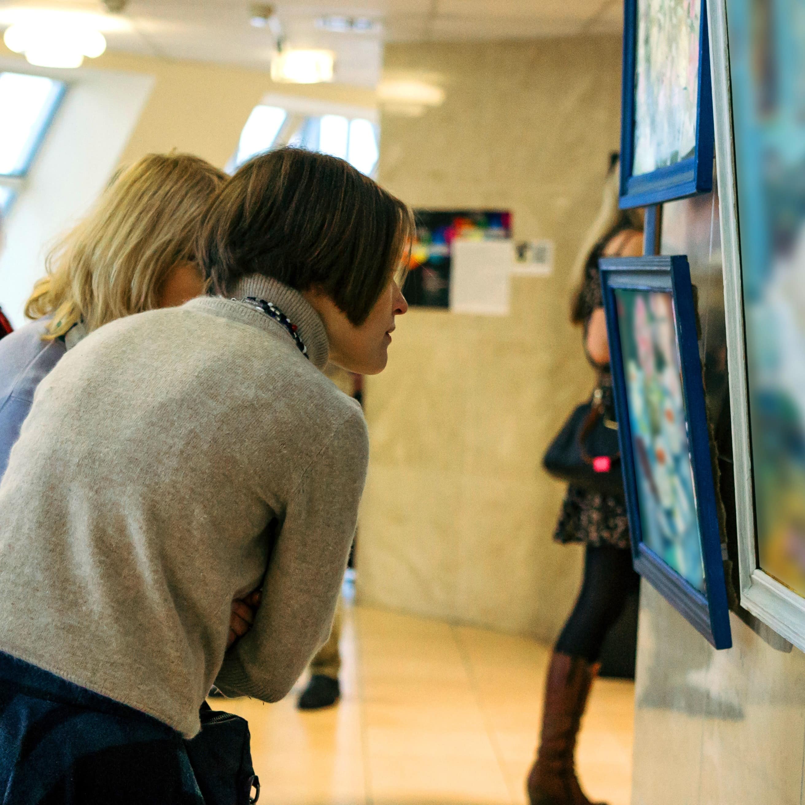 Women looking at paintings at art gallery
