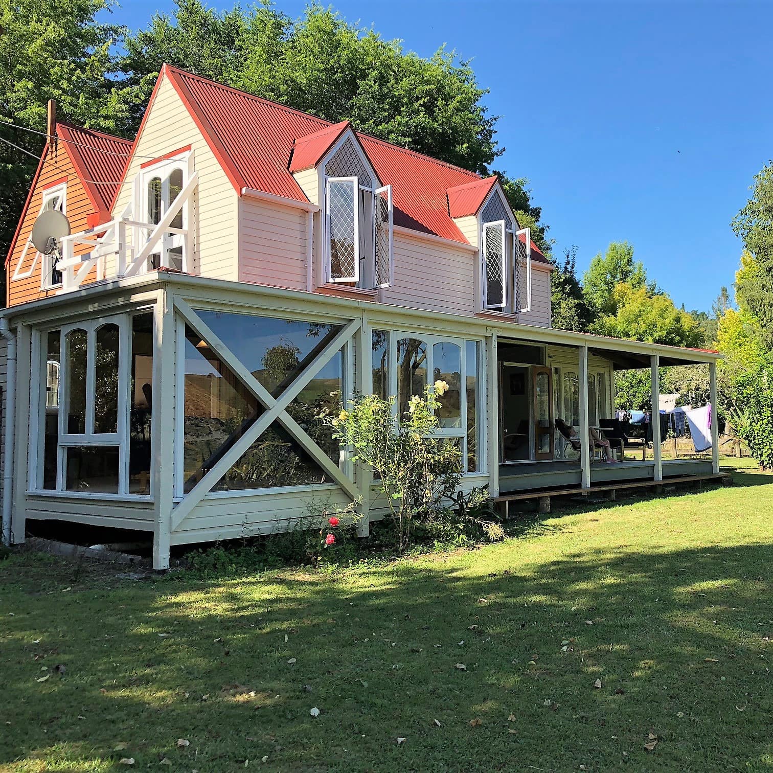 4-bedroom lodge with floor-to-ceiling windows and porch surrounded by grass and trees