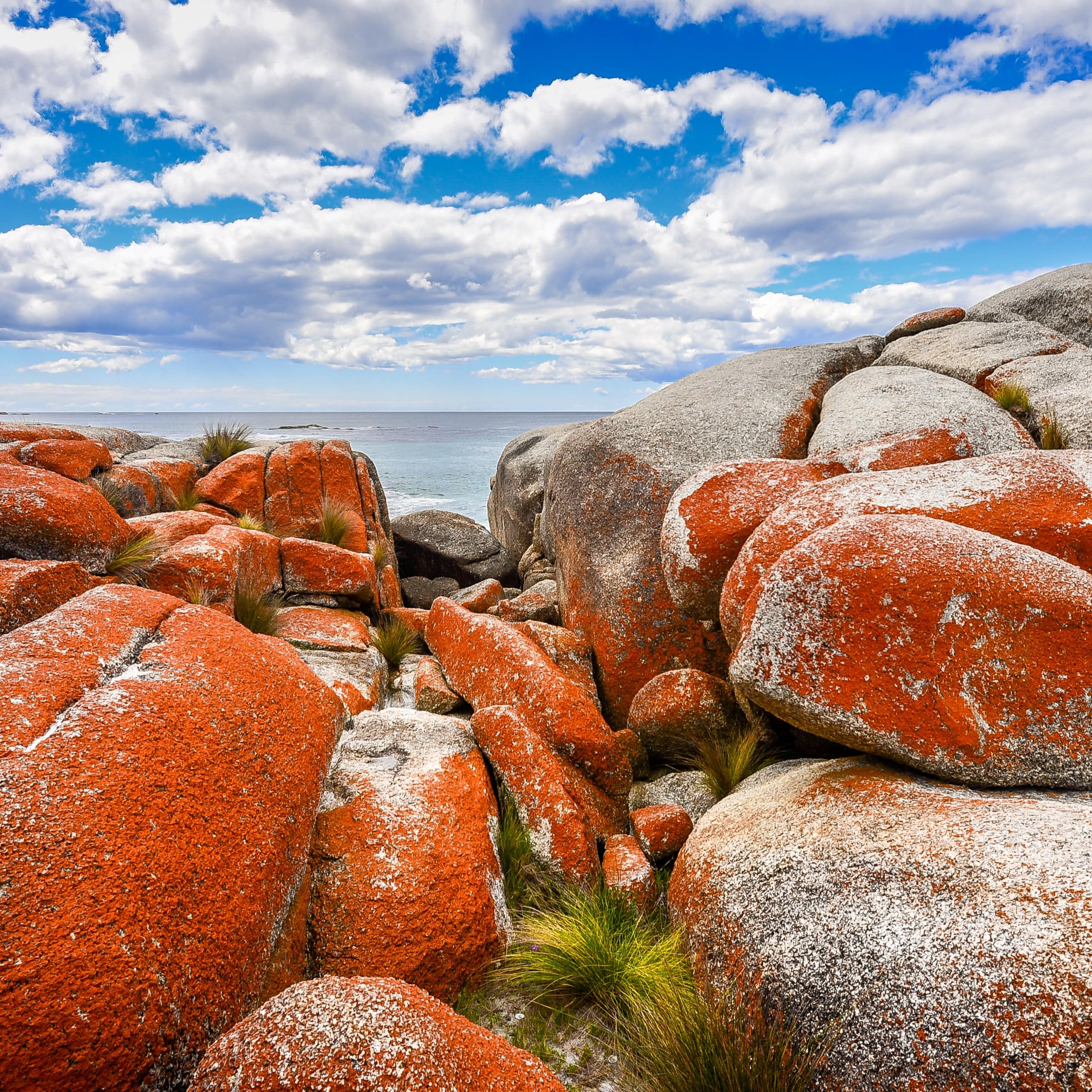 Boulders under a blue cloudy sky at Bay of Fires in Tasmania