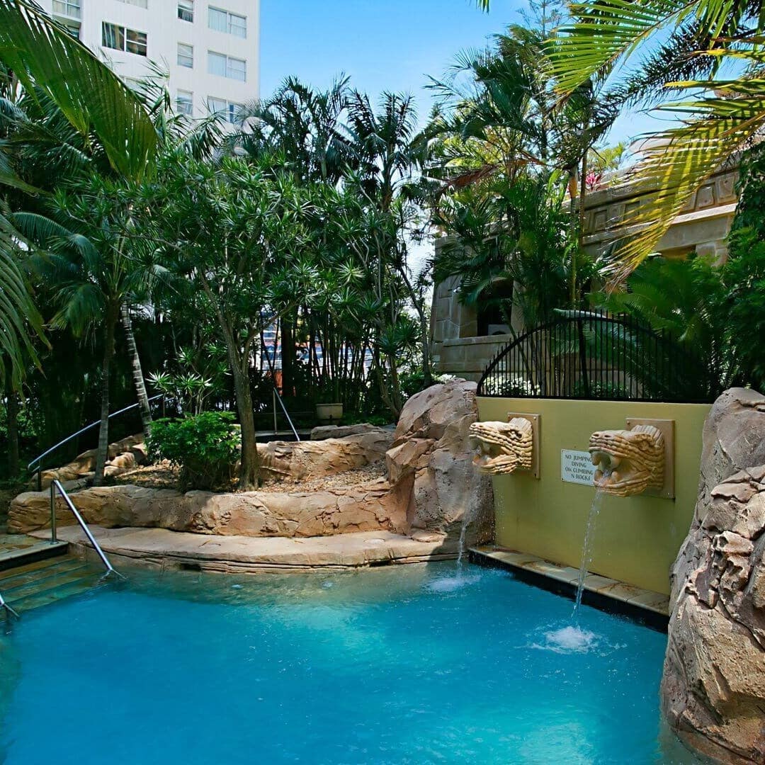 Swimming pool with rocks and dragon head fountain