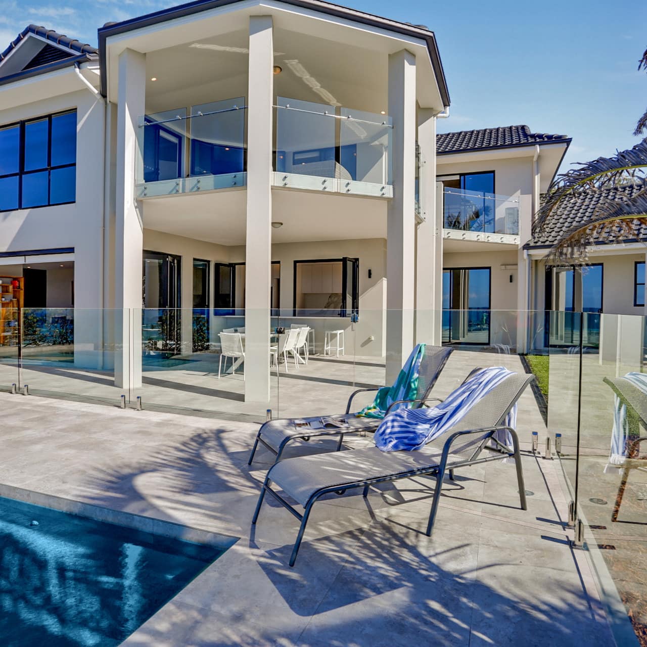 2-storey white modern luxury 6-bedroom beach house with private pool and balconies for a view of Castaways Beach