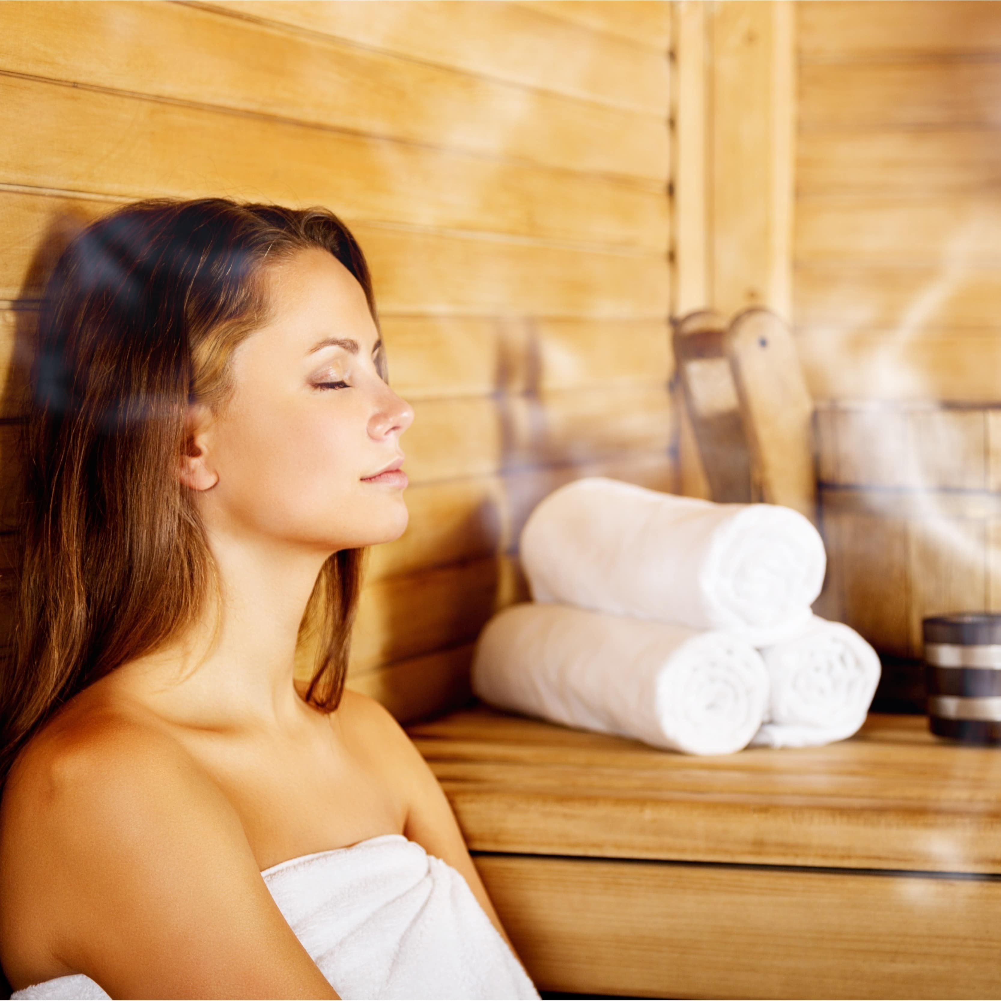 Young woman relaxing in a sauna
