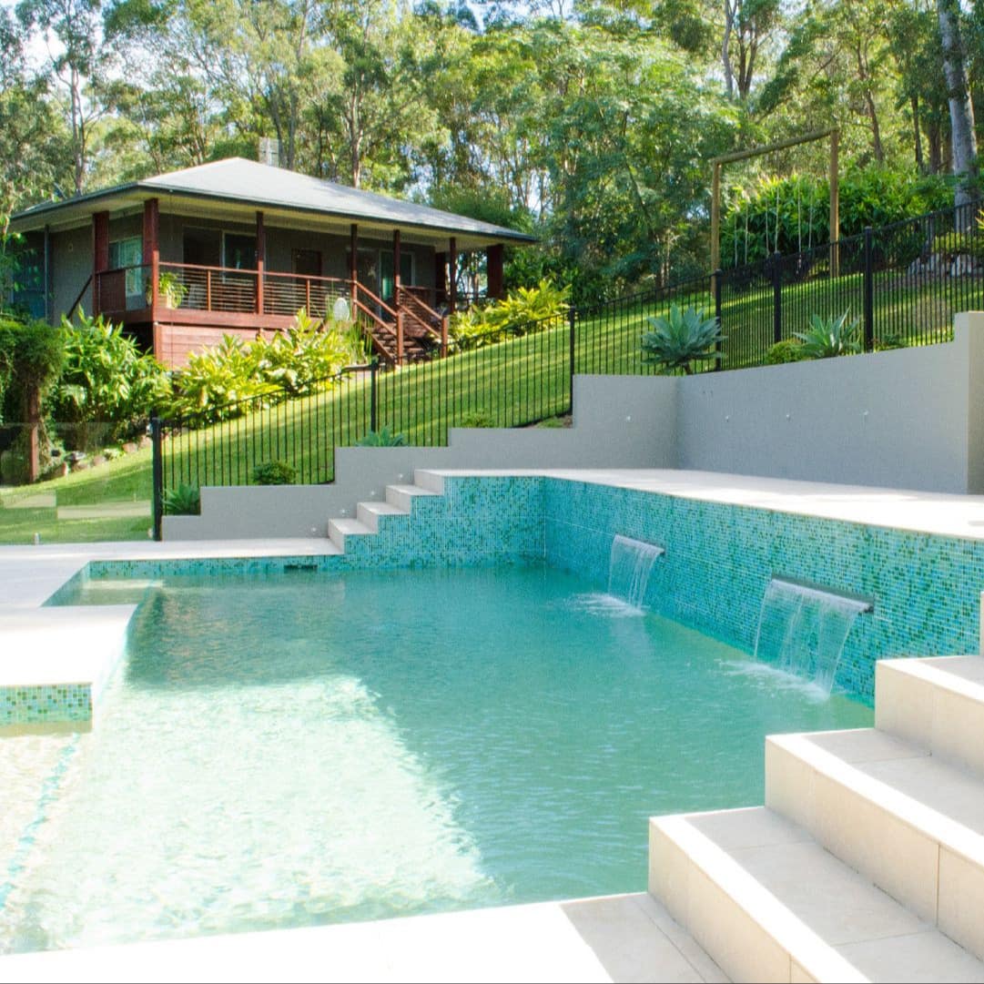 One-bedroom cottage surrounded by lush green forest with a terraced pool