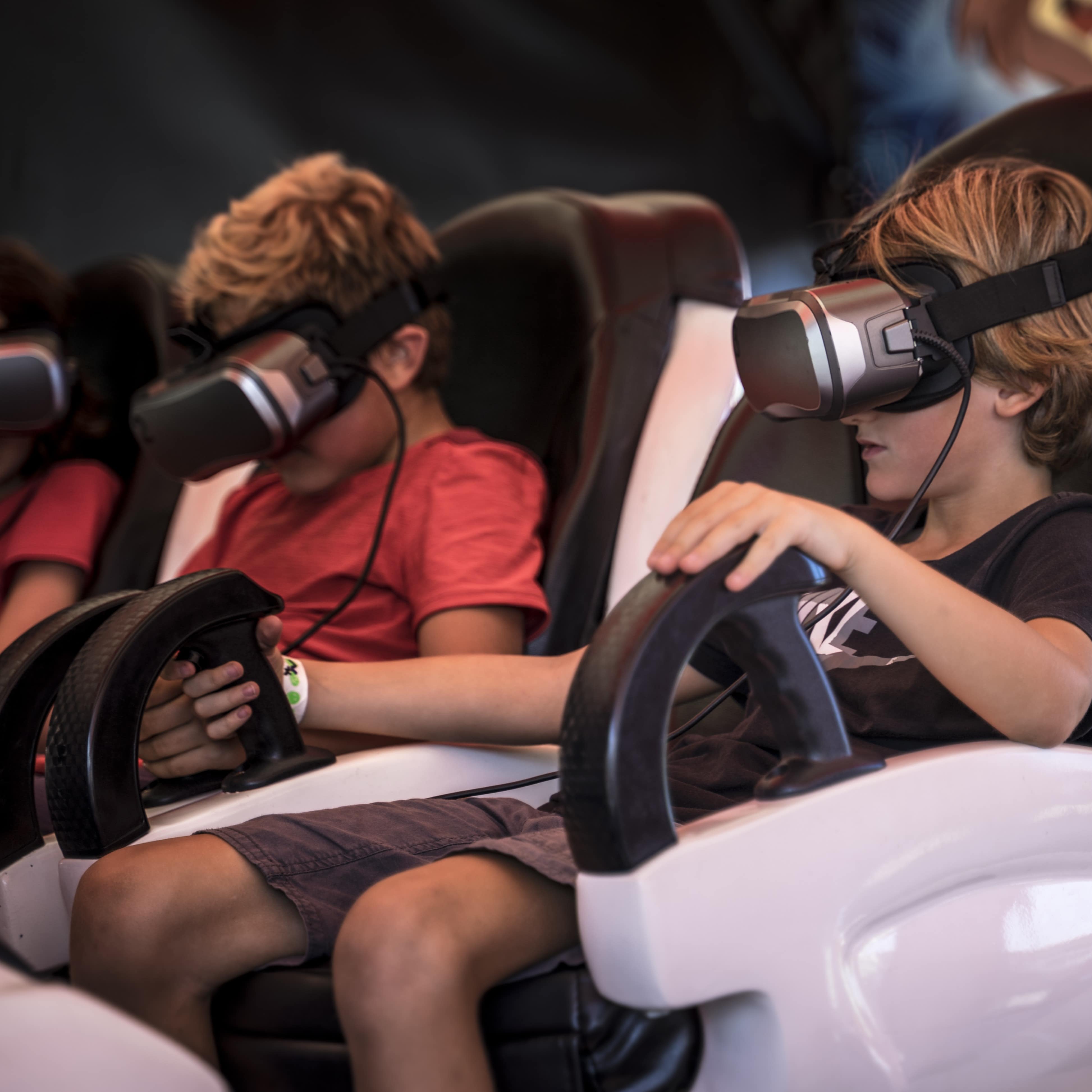 Boys on a virtual reality amusement ride