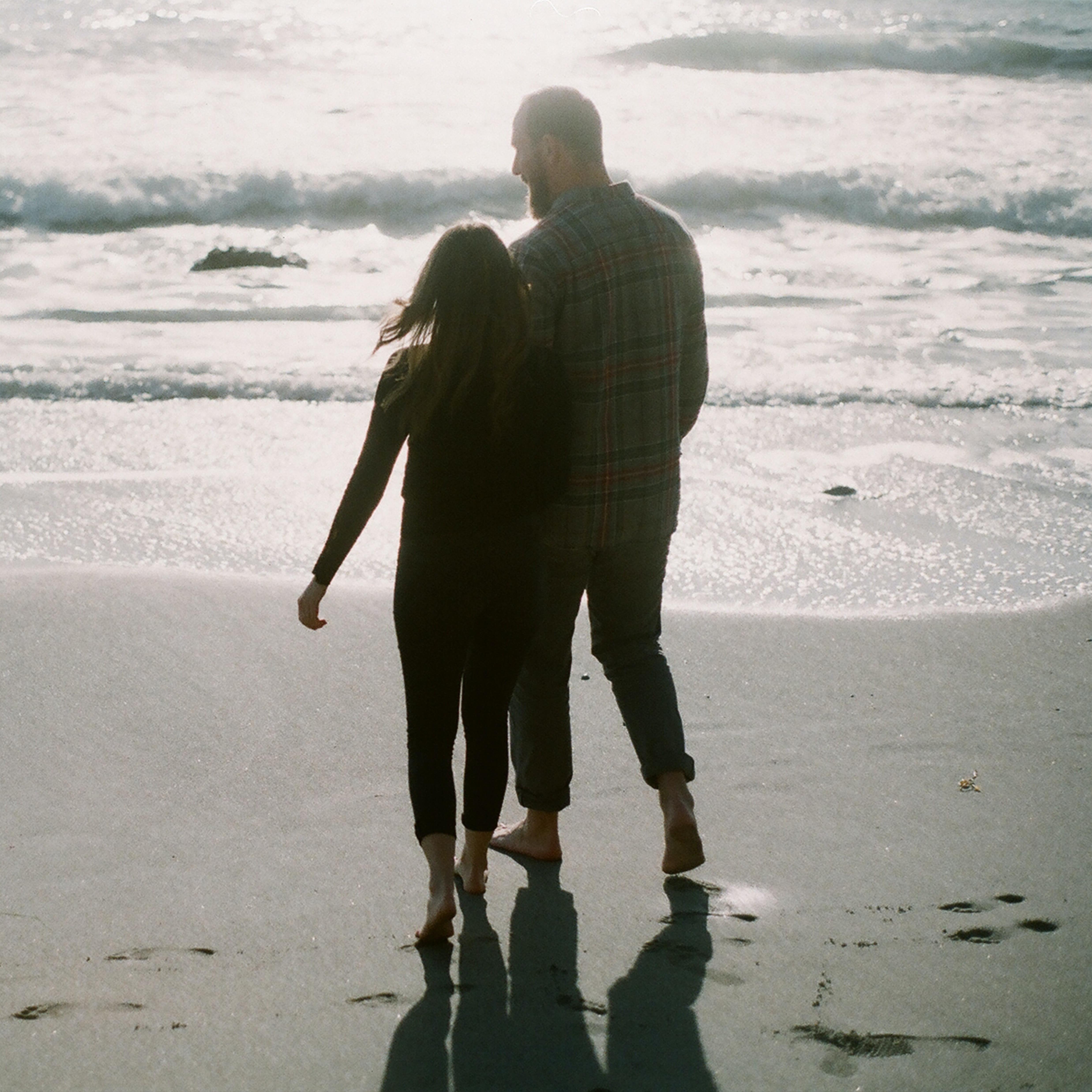 Man and woman walking on the beach