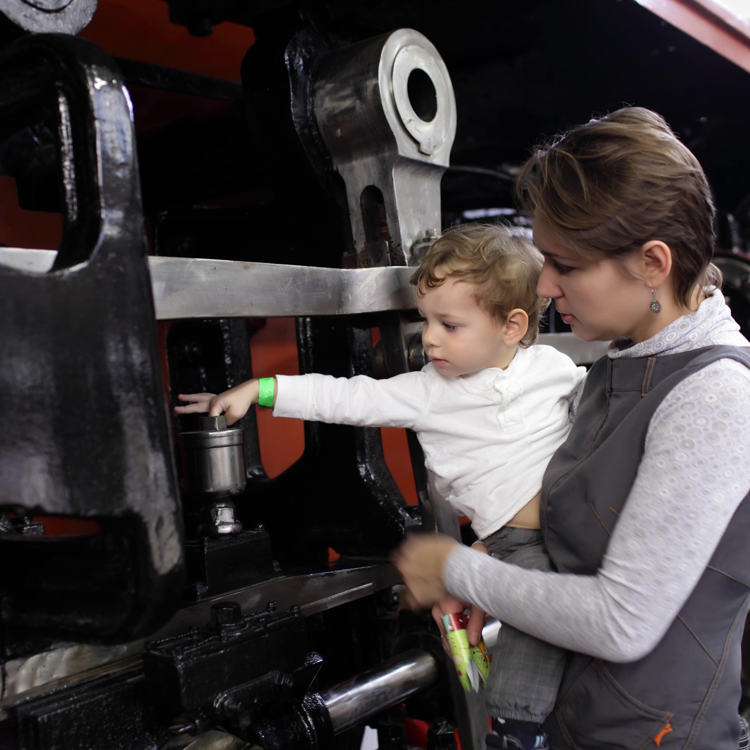 Mother holding child by locomotive