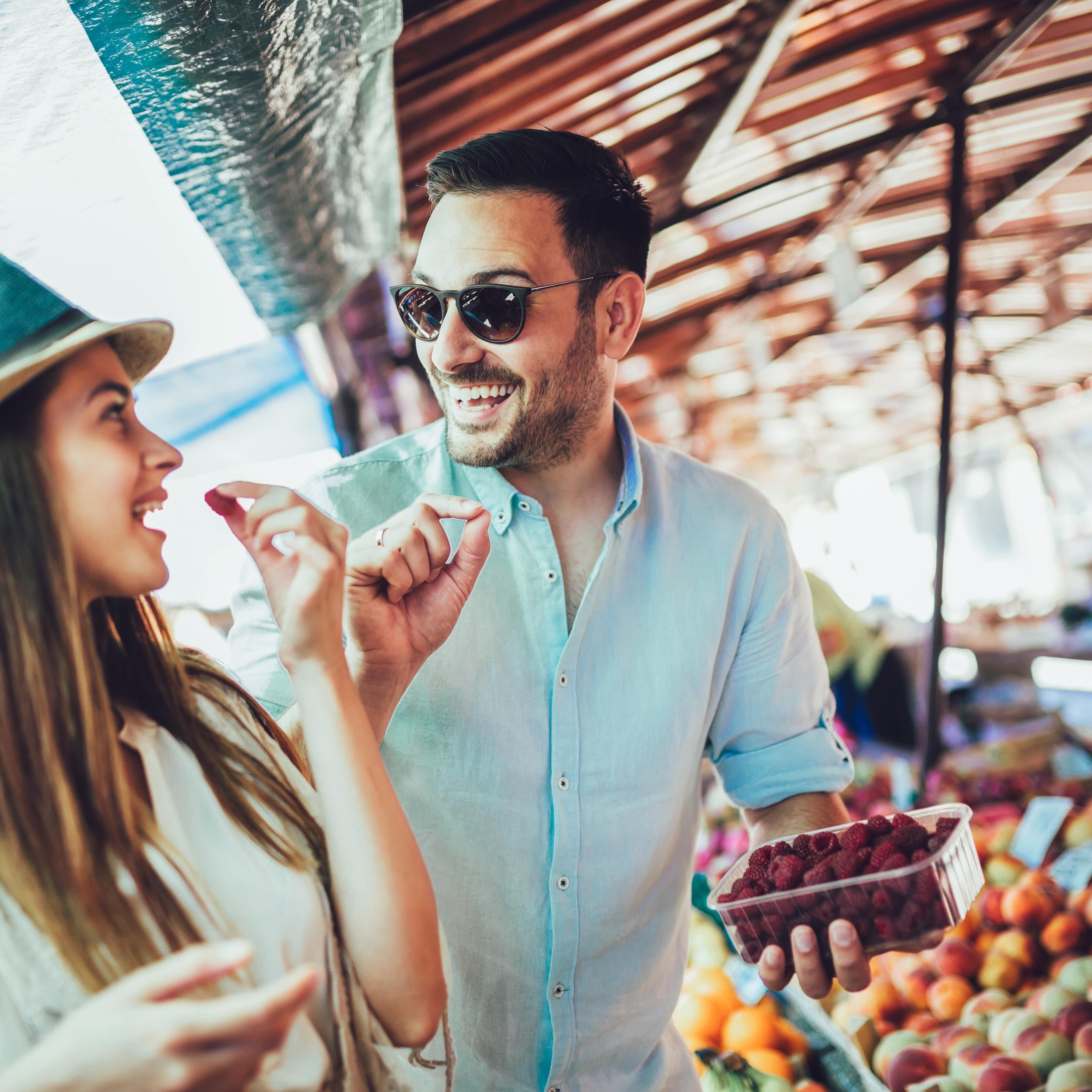 Couple buying fruit at an outdoor market