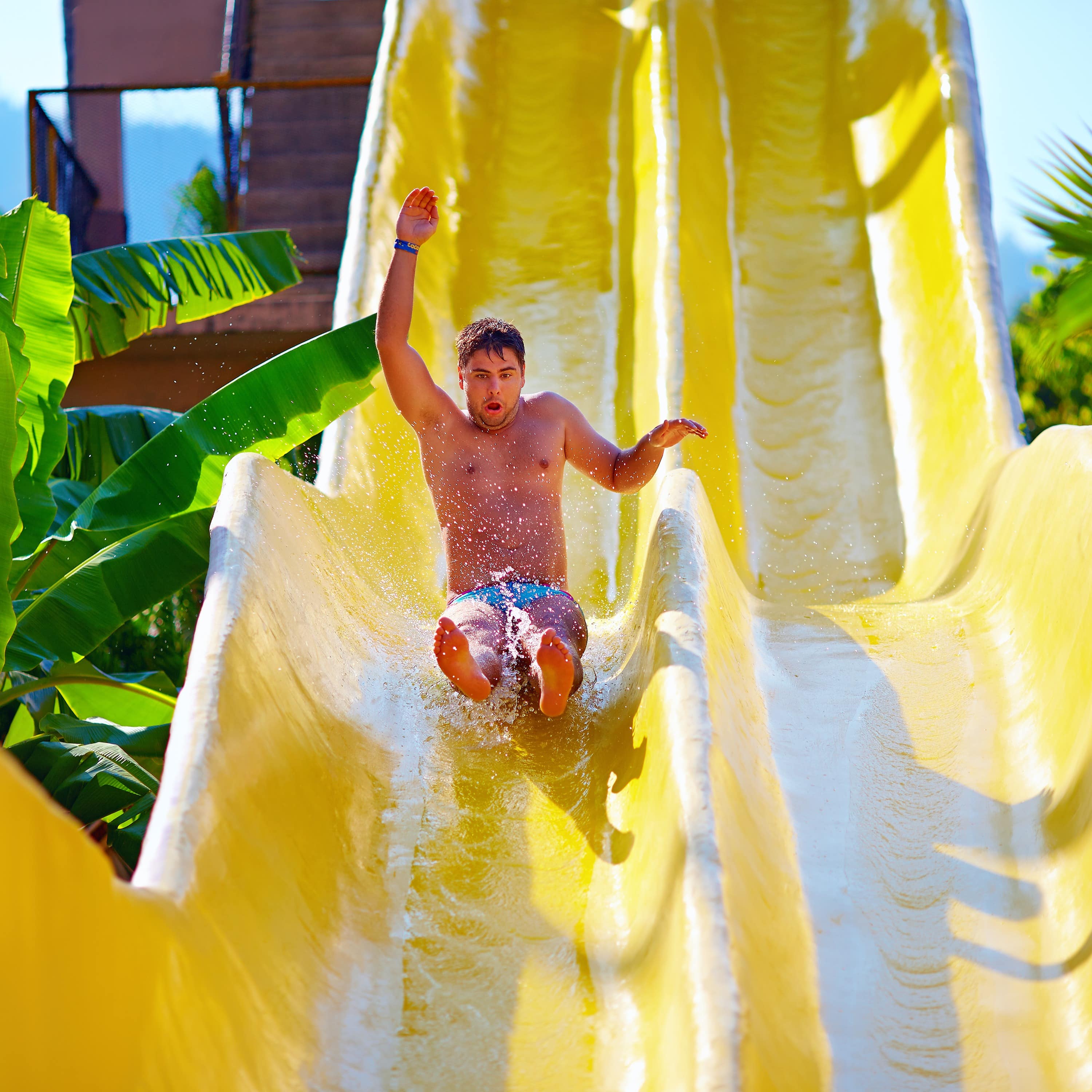 Man going down water slide