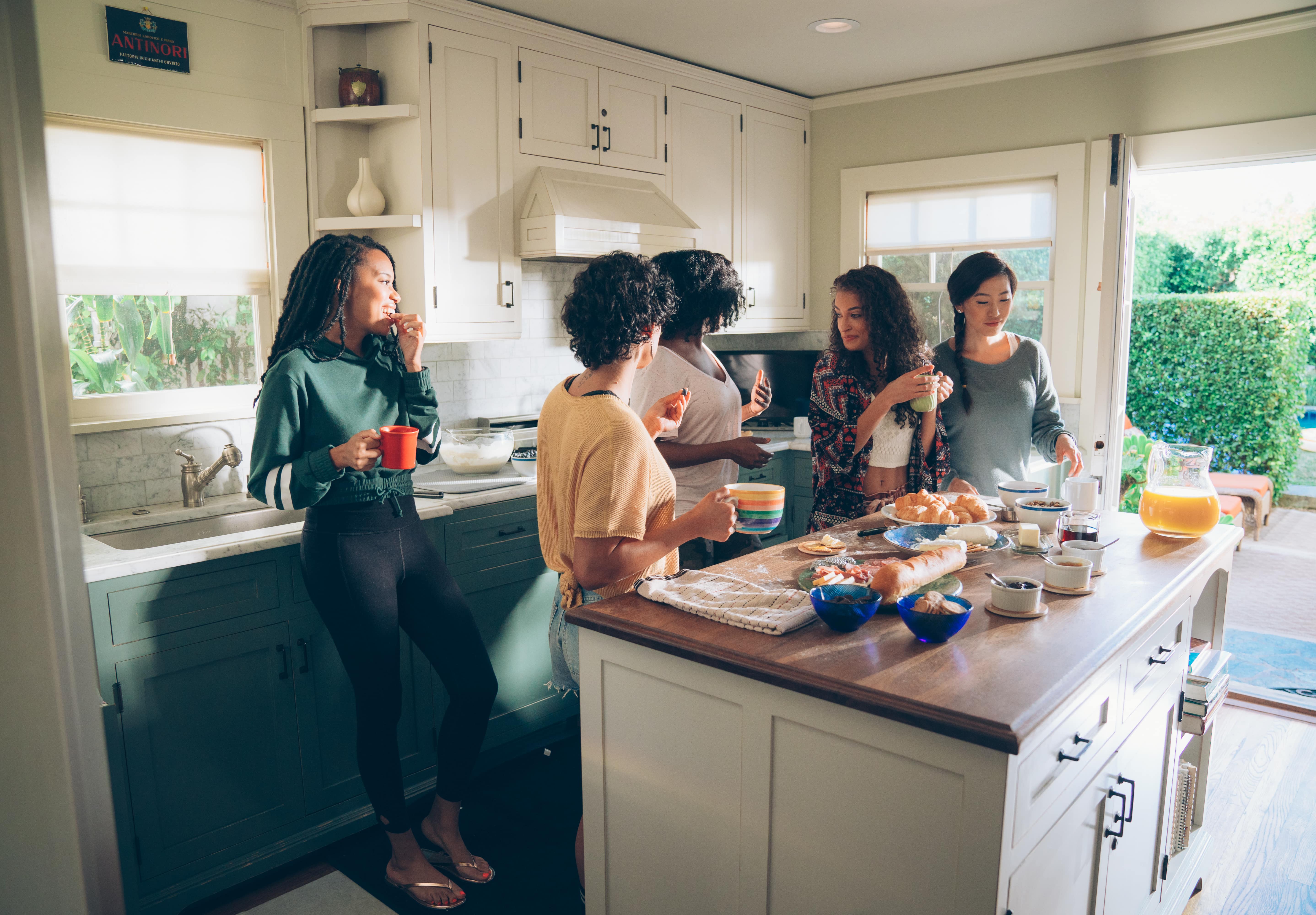 group of women eating brunch in a kitchen