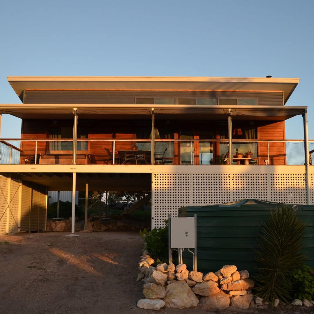 A family-friendly beach house with a balcony overlooking the sea