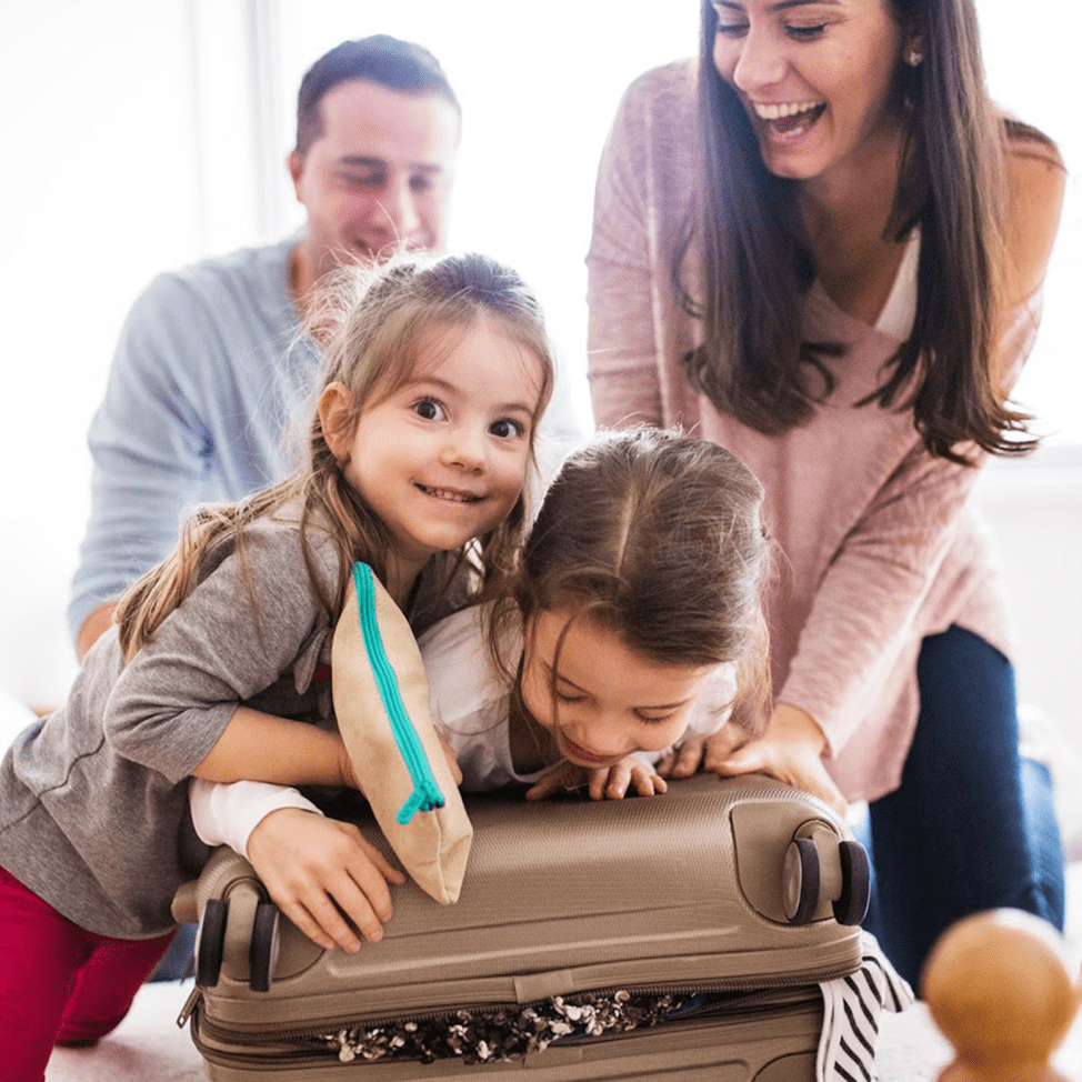 packing clothes (kids sitting on a suitcase)