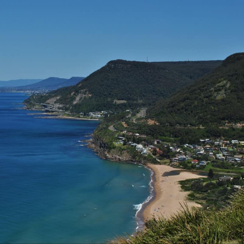 View of Stanley Tops from Bald Hill Lookout with lush green hills, the beach and aquamarine waters