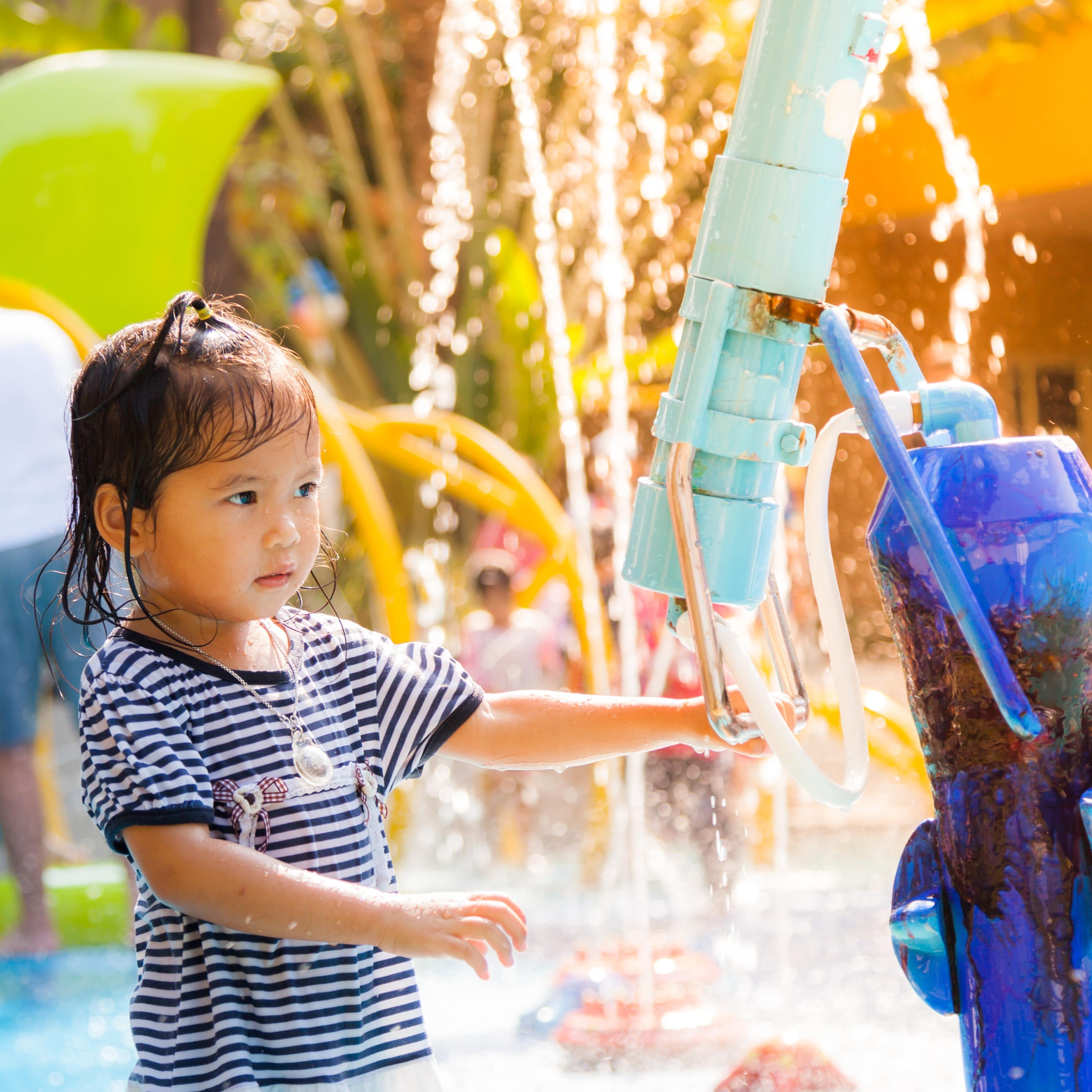 Little girl playing in water park