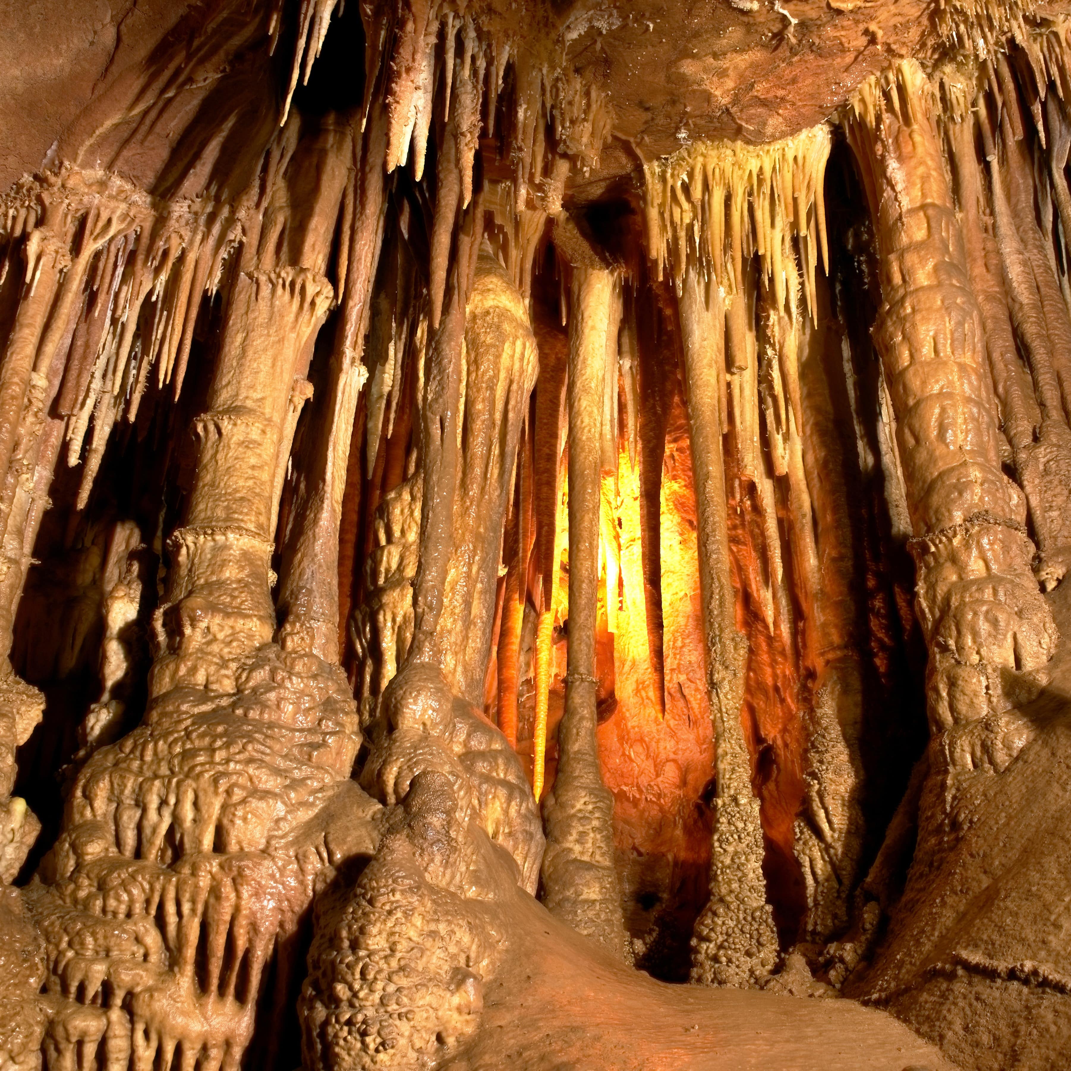 Interior of limestone cave with golden glow from lights
