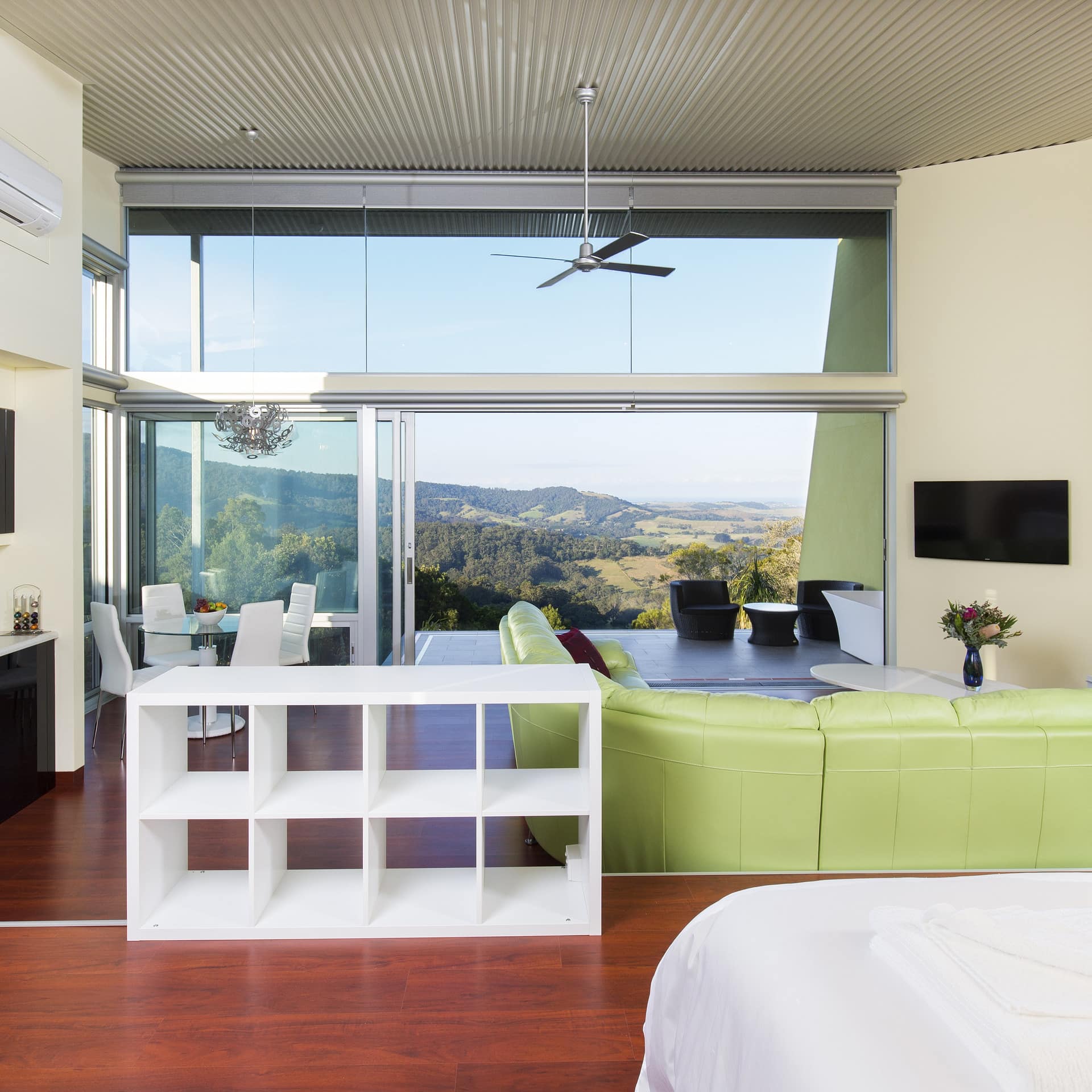 Spacious and bright living area looking through a large floor-to-ceiling window with a stunning view of the mountains