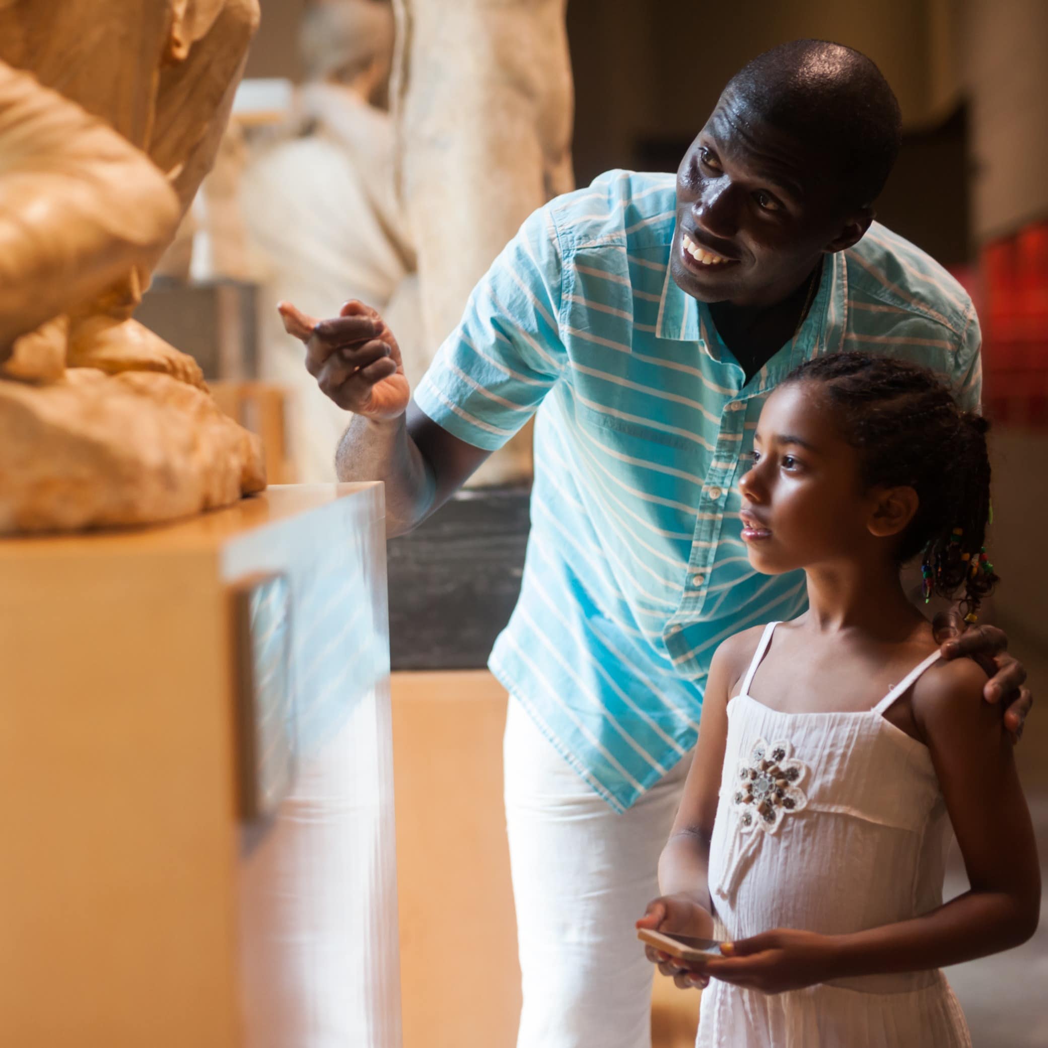 Man and daughter looking at history exhibit
