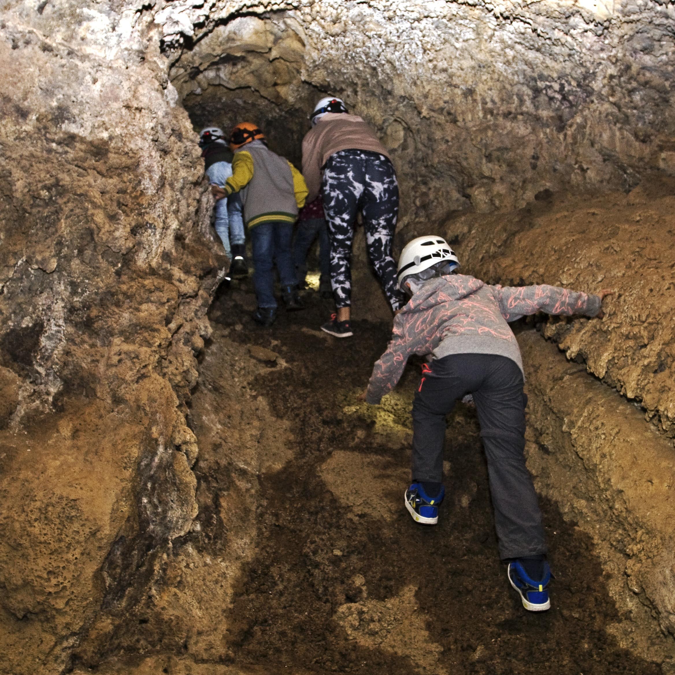Family exploring underground cave