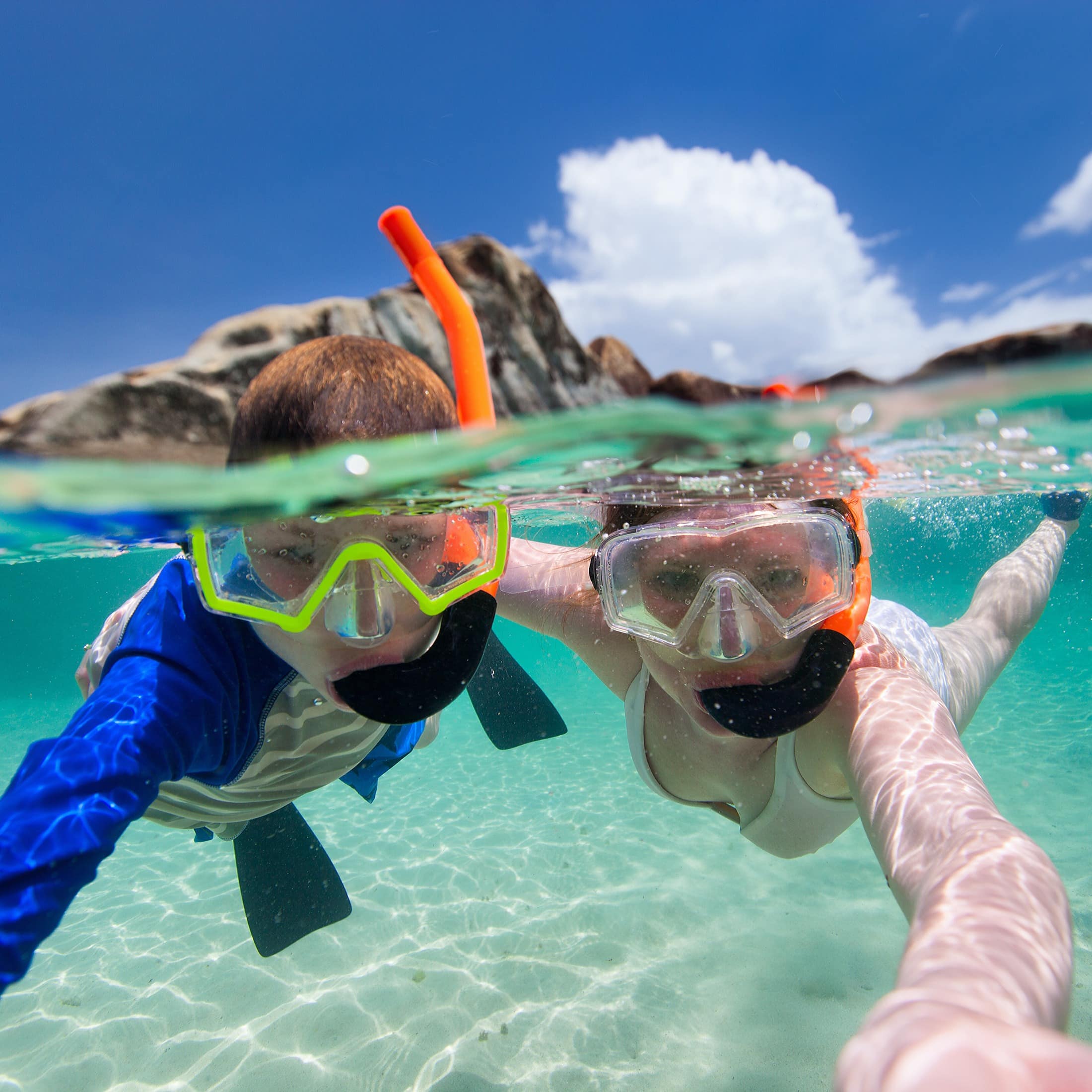 Family snorkelling in tropical water