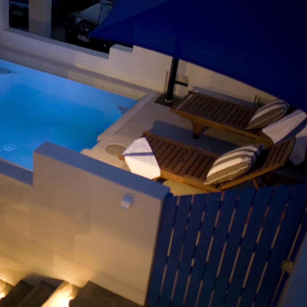 Private deep plunge pool with lounge chairs in beachside luxury villa