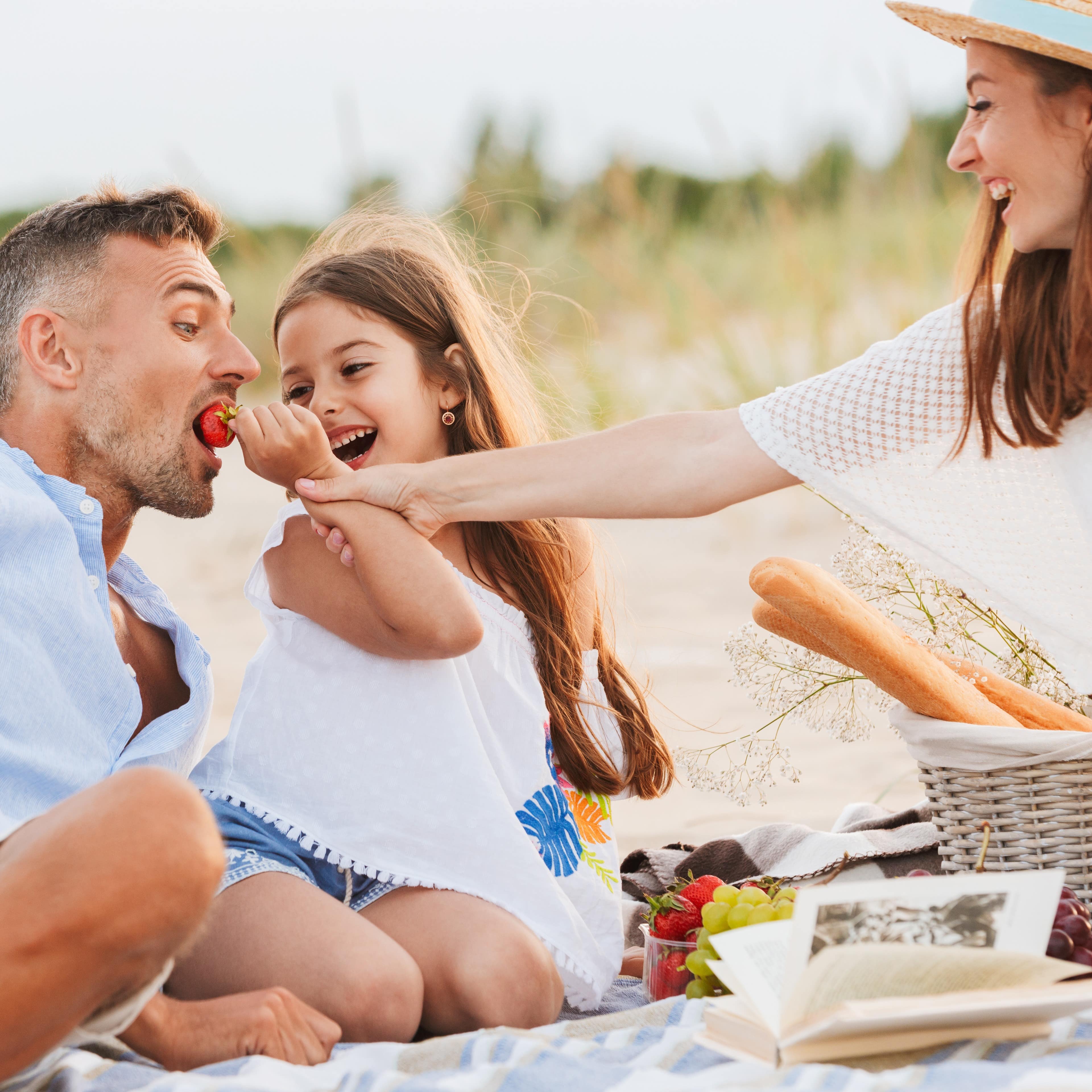 Family having a beach picnic