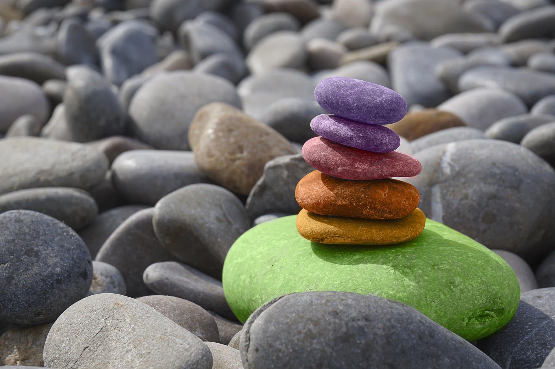 colourful stones in a pile surrounded by grey stones