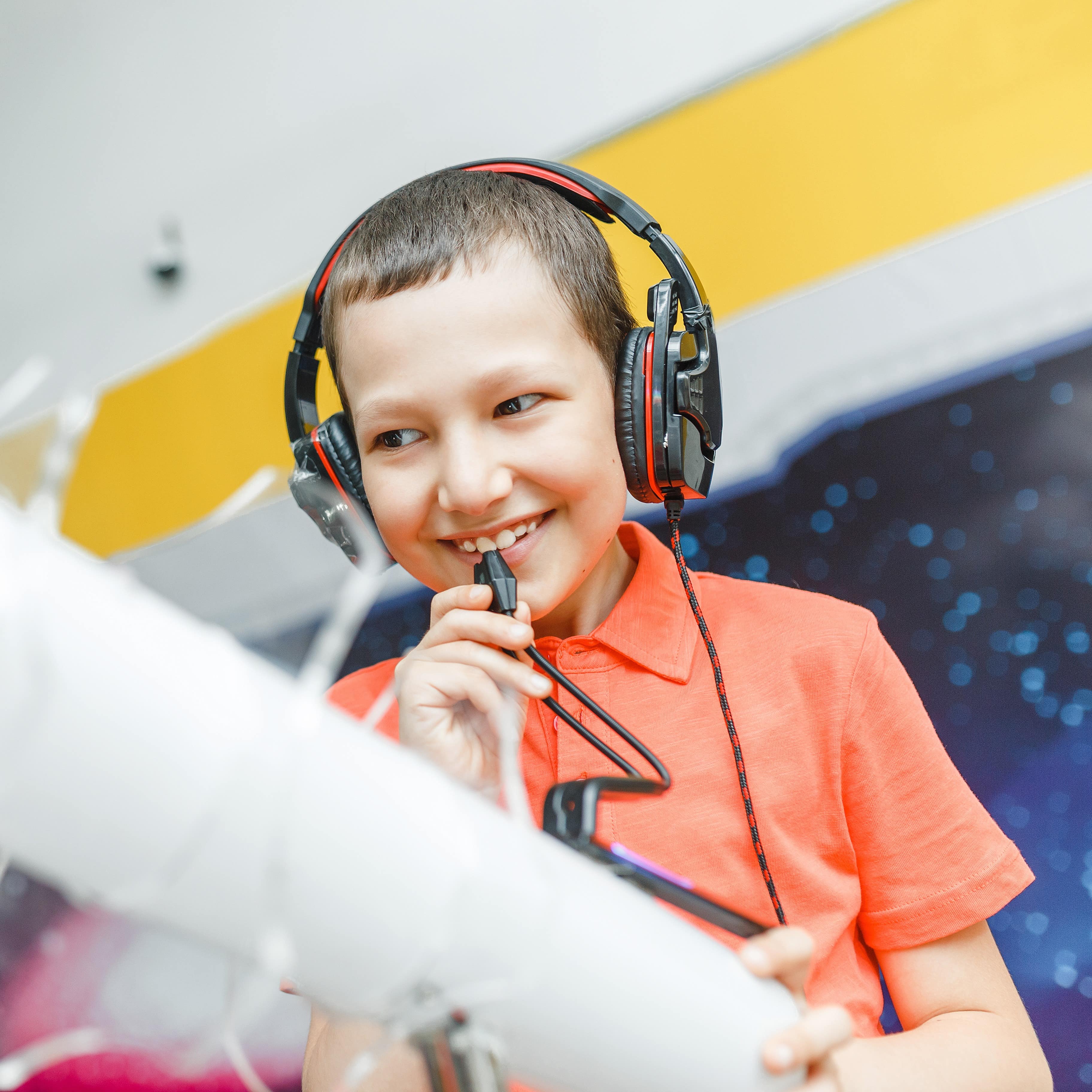Little boy wearing headphones and speaking into mic