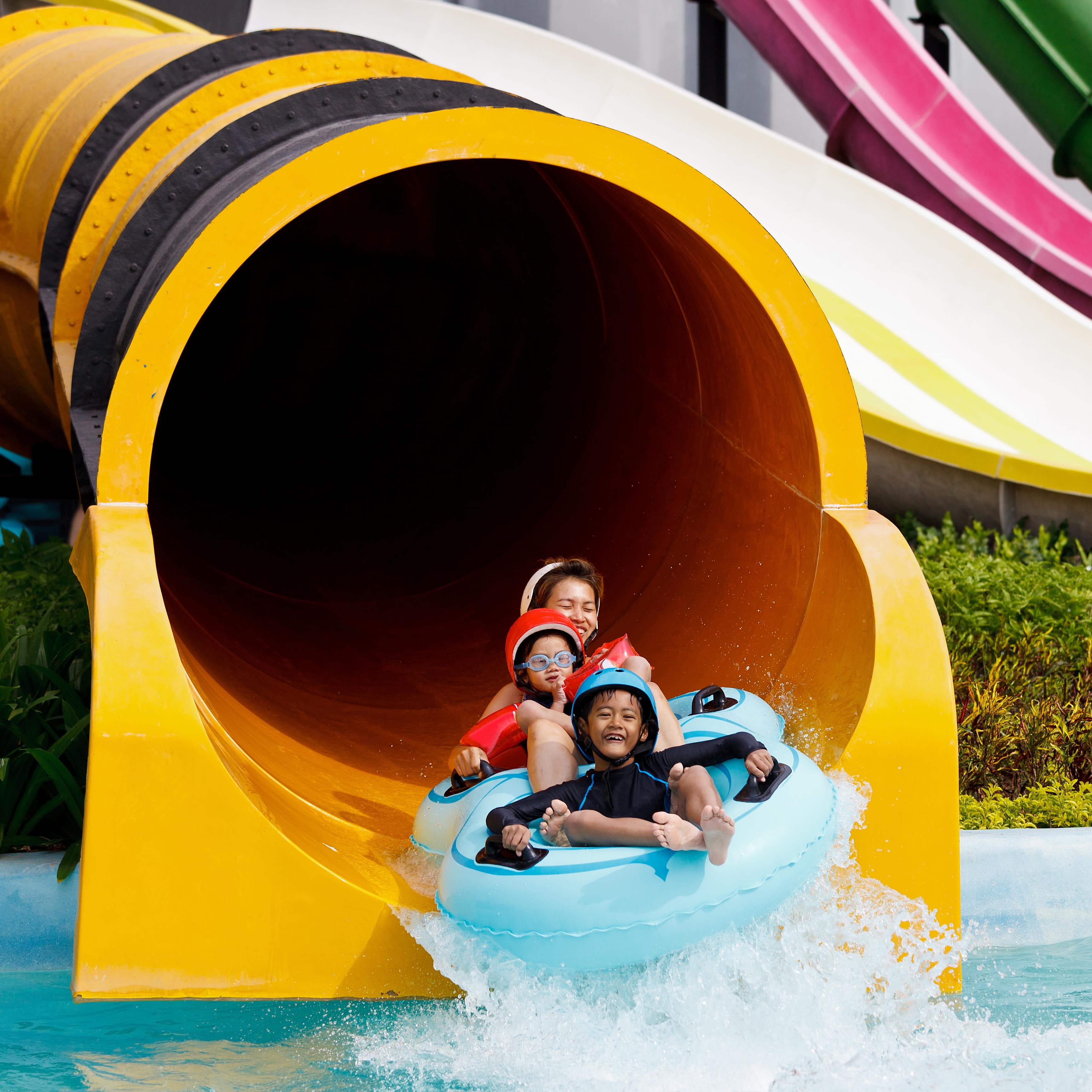 Family coming out of tube at water park