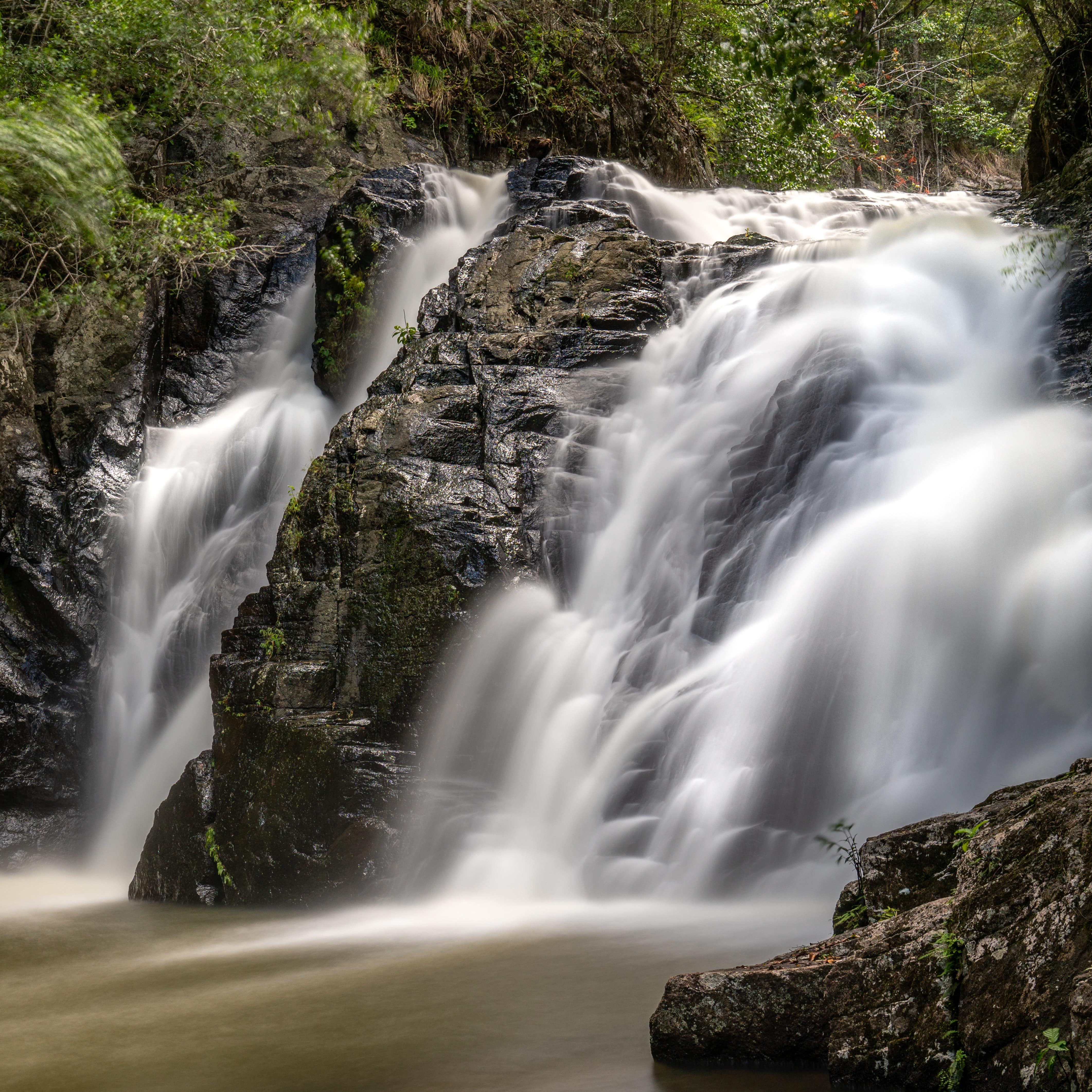 Waterfall at Mount Hypipamee, tropical north Queensland, Australia against lush rocky, green background