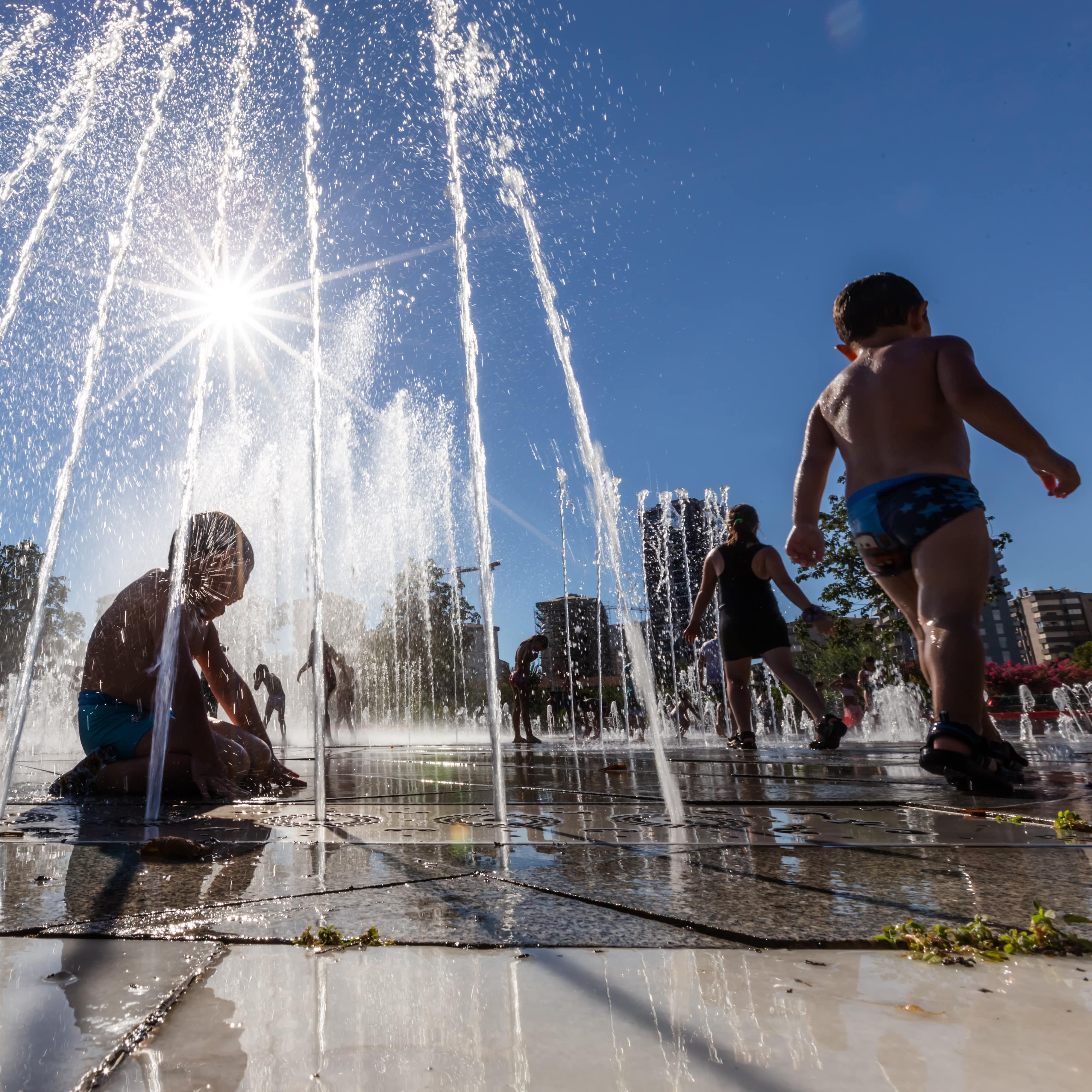 Kids playing in city fountains