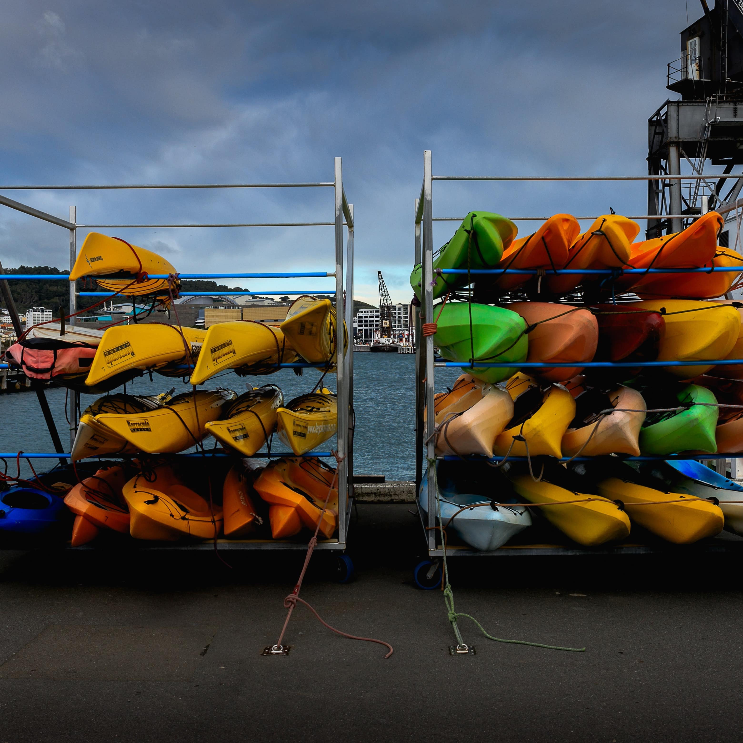 Colourful kayaks stacked for rental in Wellington, New Zealand