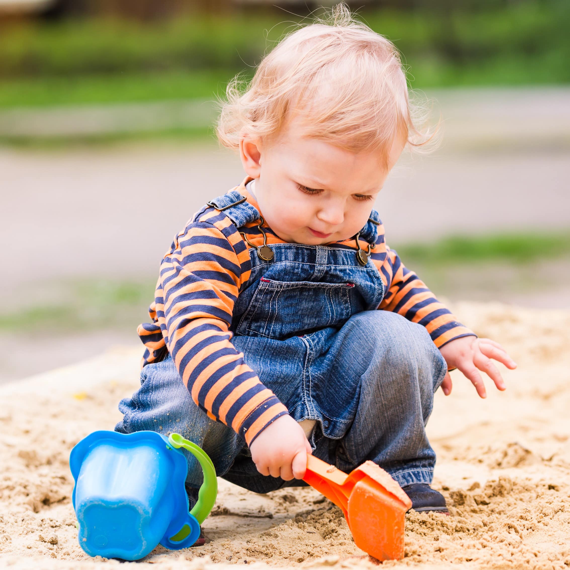 Toddler boy playing in the sand