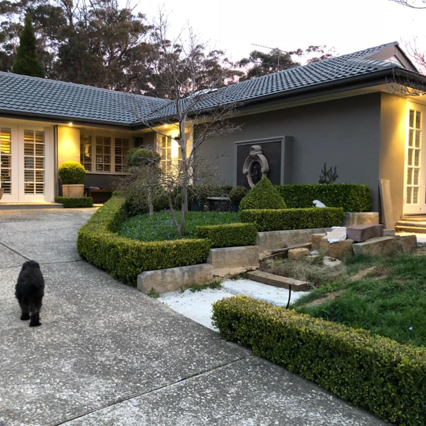 Katoomba bed and breakfast with sculpted formal gardens and inviting entry with inviting lighting and double French doors