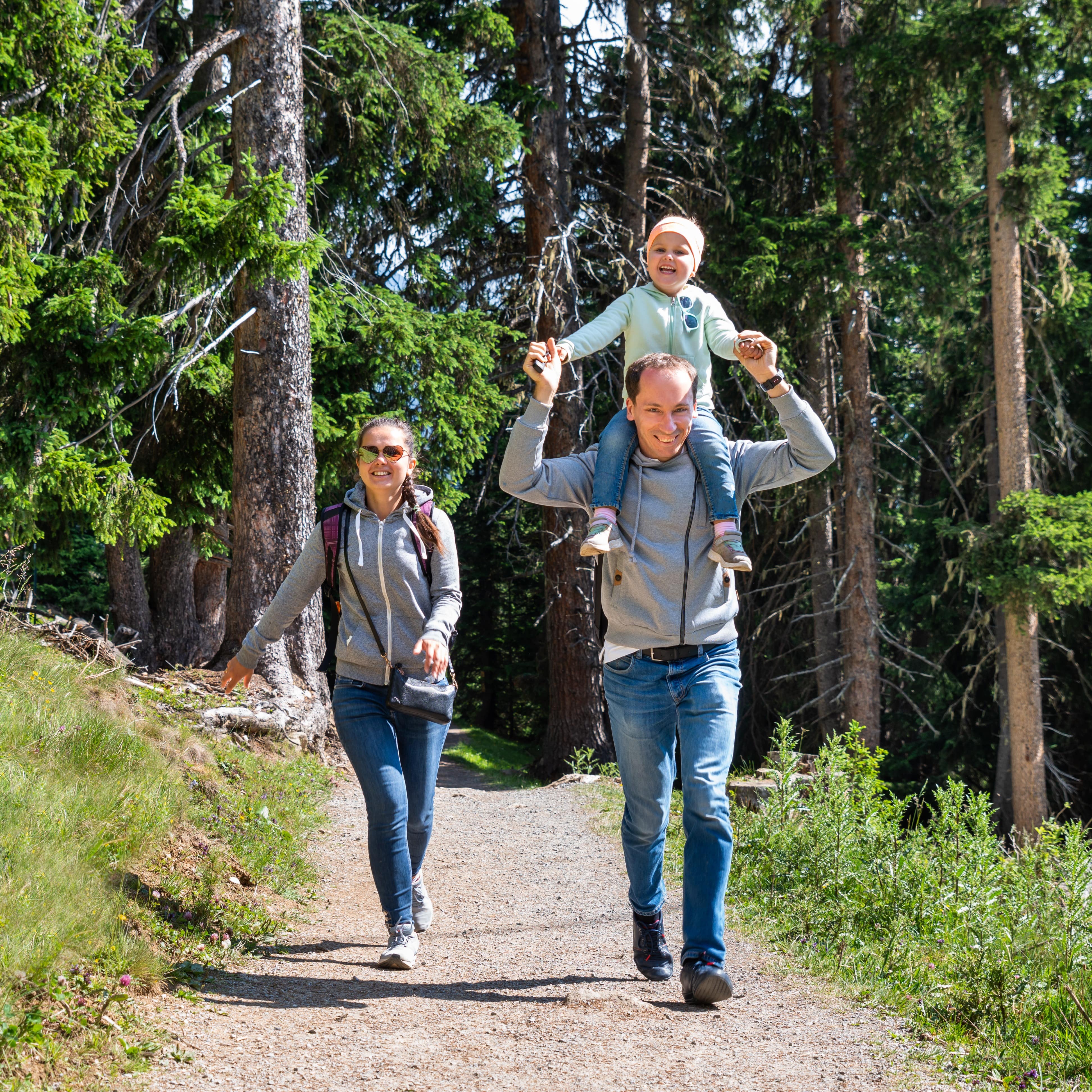 Family walking on wooded trail
